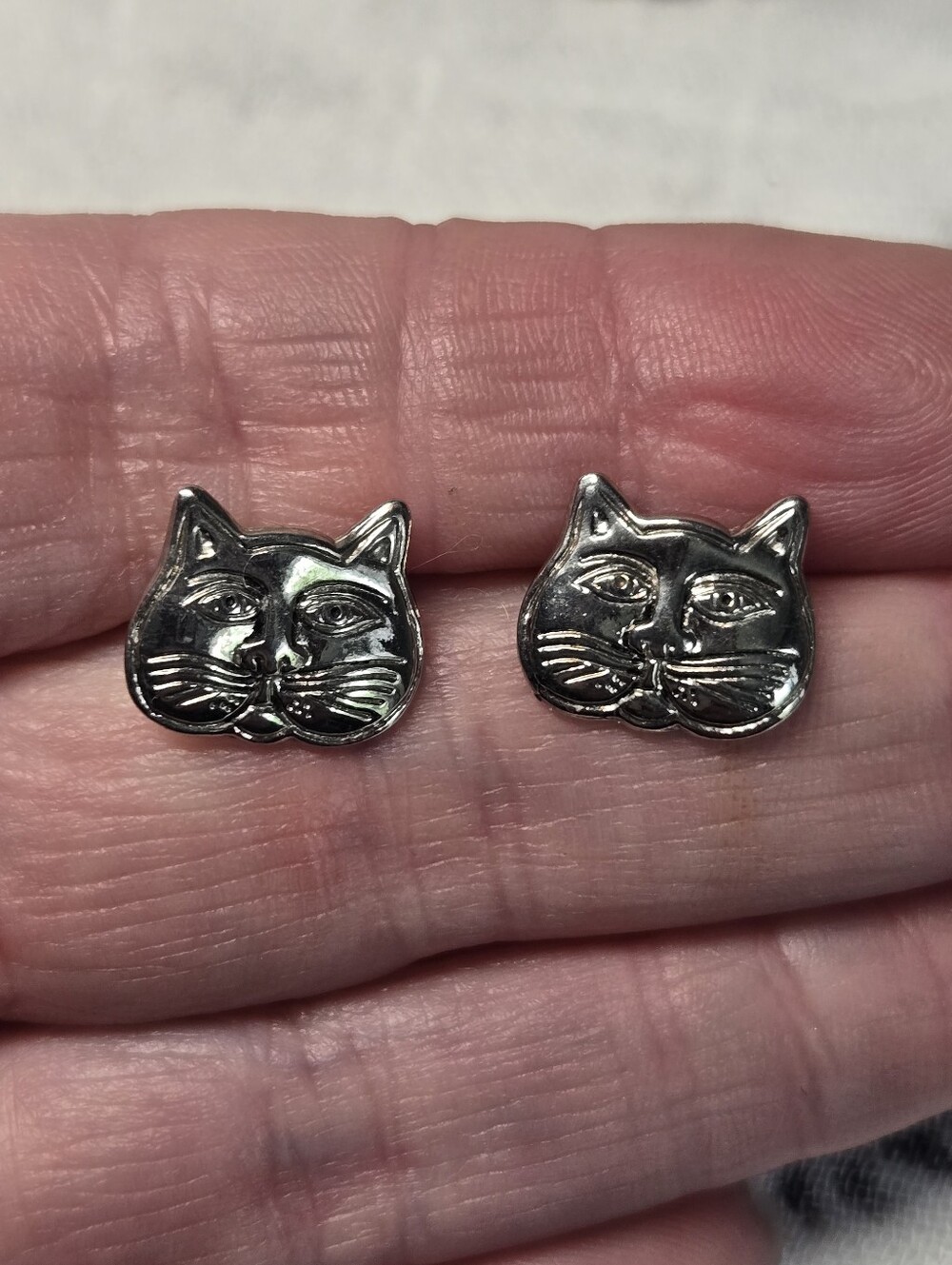 Laurel Burch silver plate stud earrings feature a stylized cat face design